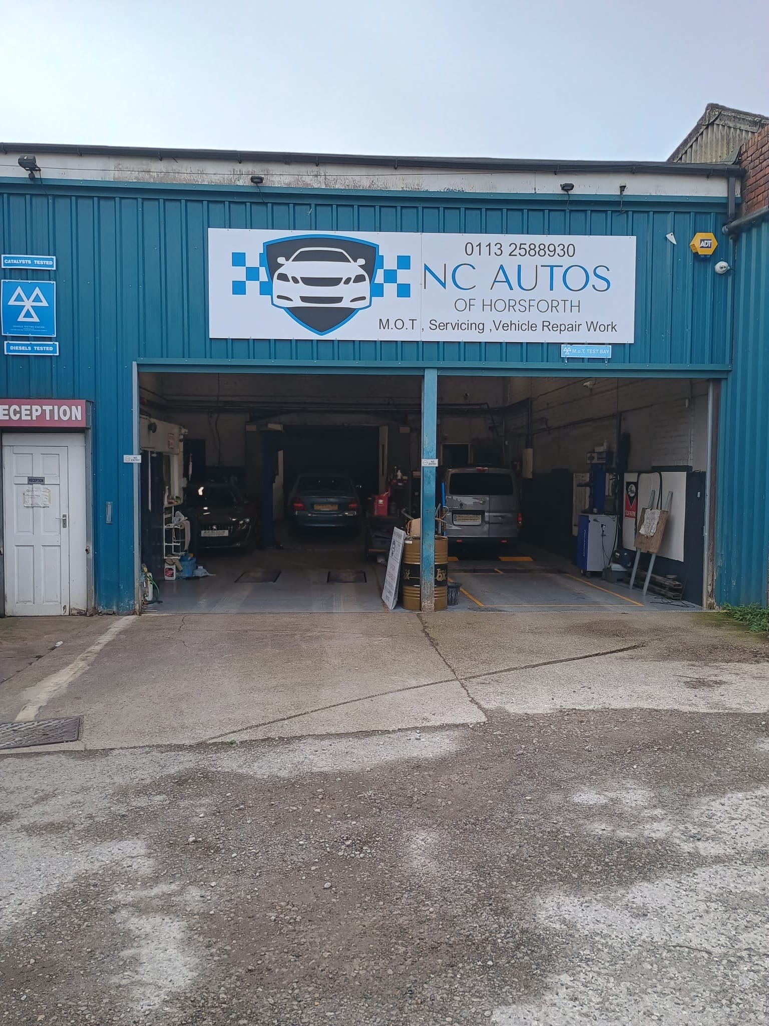 The blue NC Autos of Horsforth workshop with its two garage bays and current sign